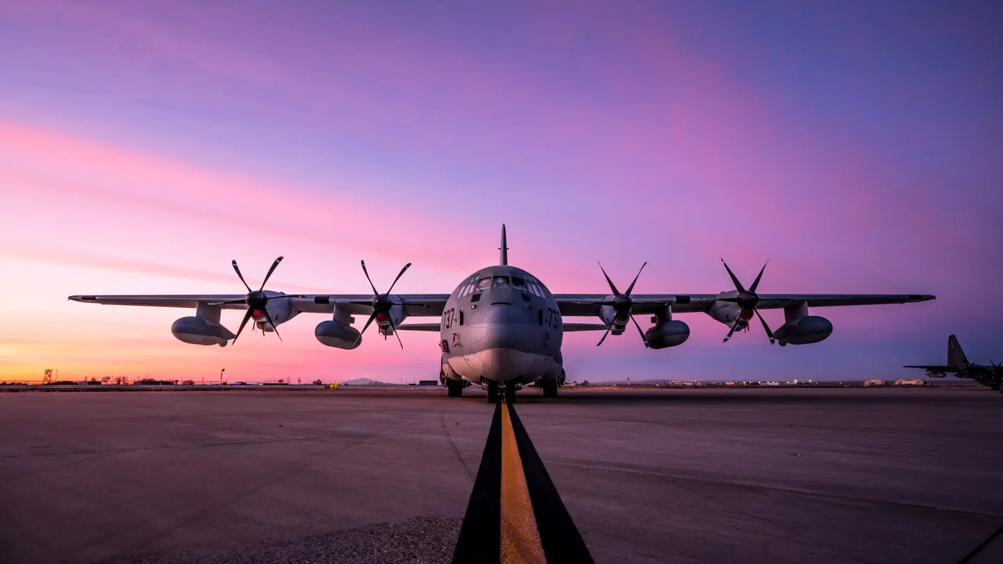A U.S. Air Force C-130 Hercules on the flightline at sunrise