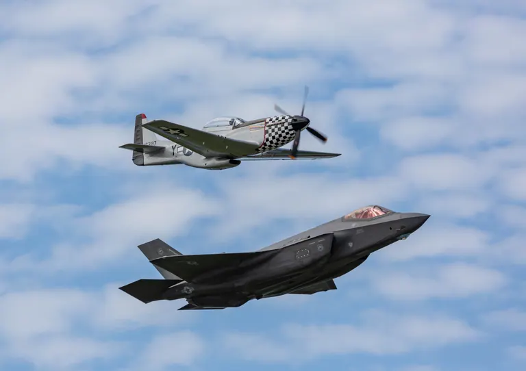 A P-51 Mustang and an F-35 Lightning II flying in heritage formation